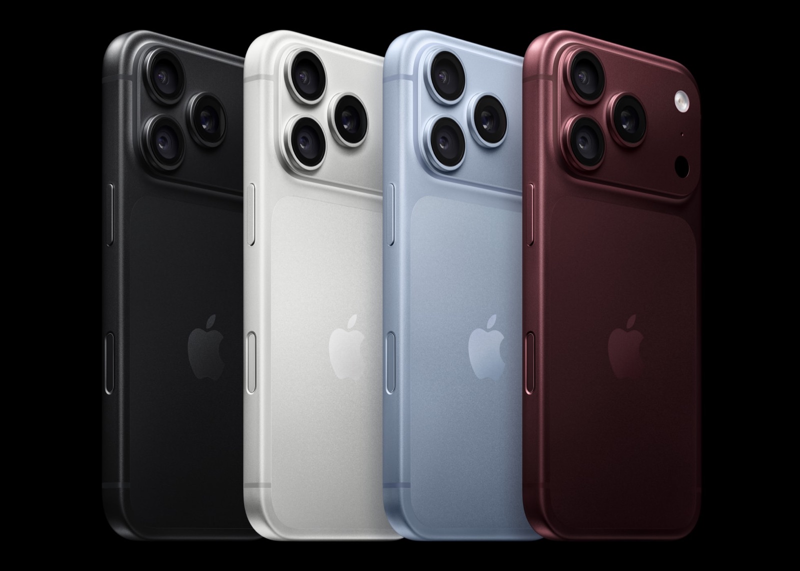 The backs of four iPhone 18 Pro handsets angled in a row against a black background, in black, silver, glacier light blue and burgundy, each with a triple camera unit.